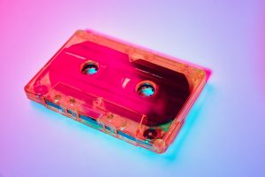 Retro cassette tape on a colorful neon background